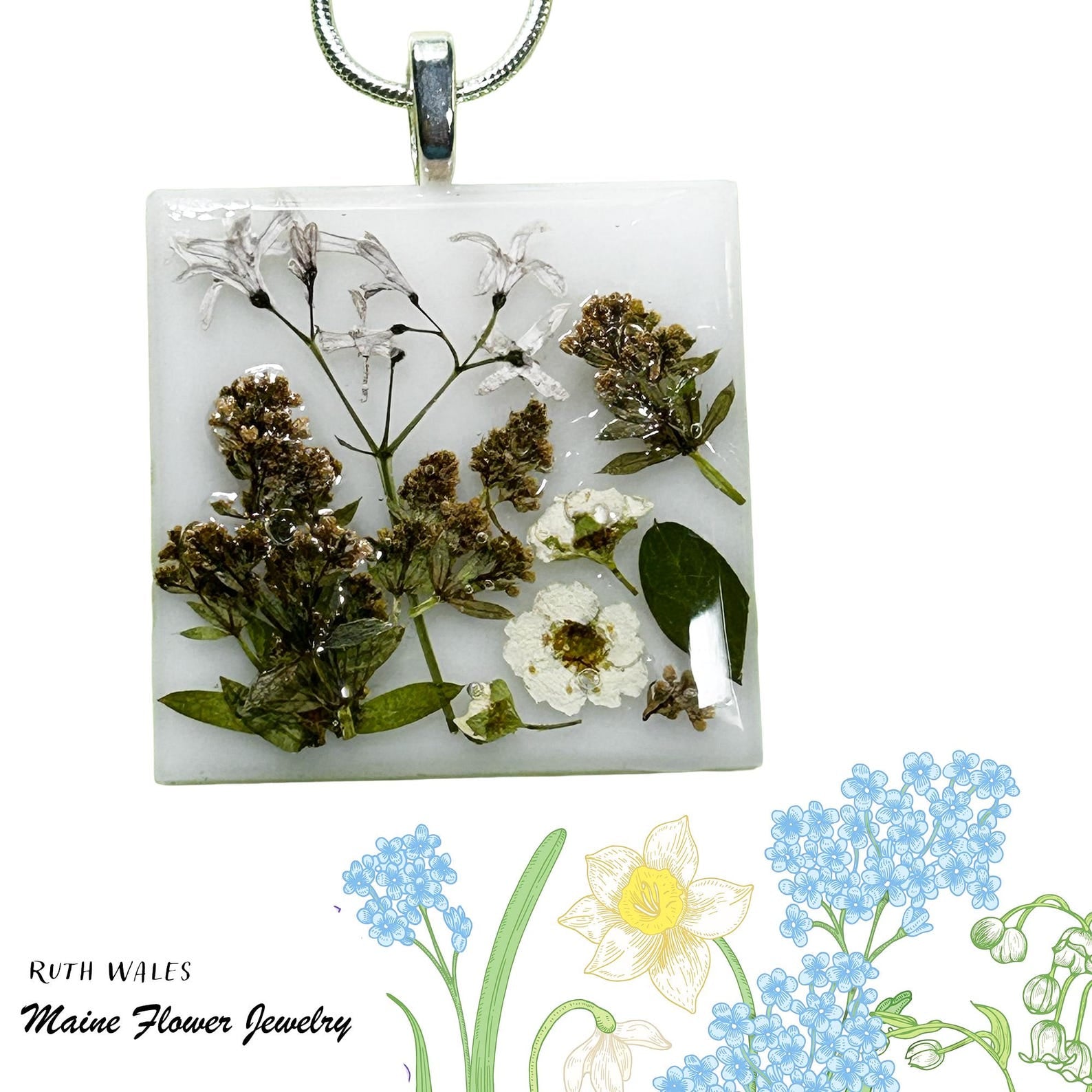 Square pendant with pressed flowers and greenery on a white background, featuring 'Ruth Wales Maine Flower Jewelry'.
