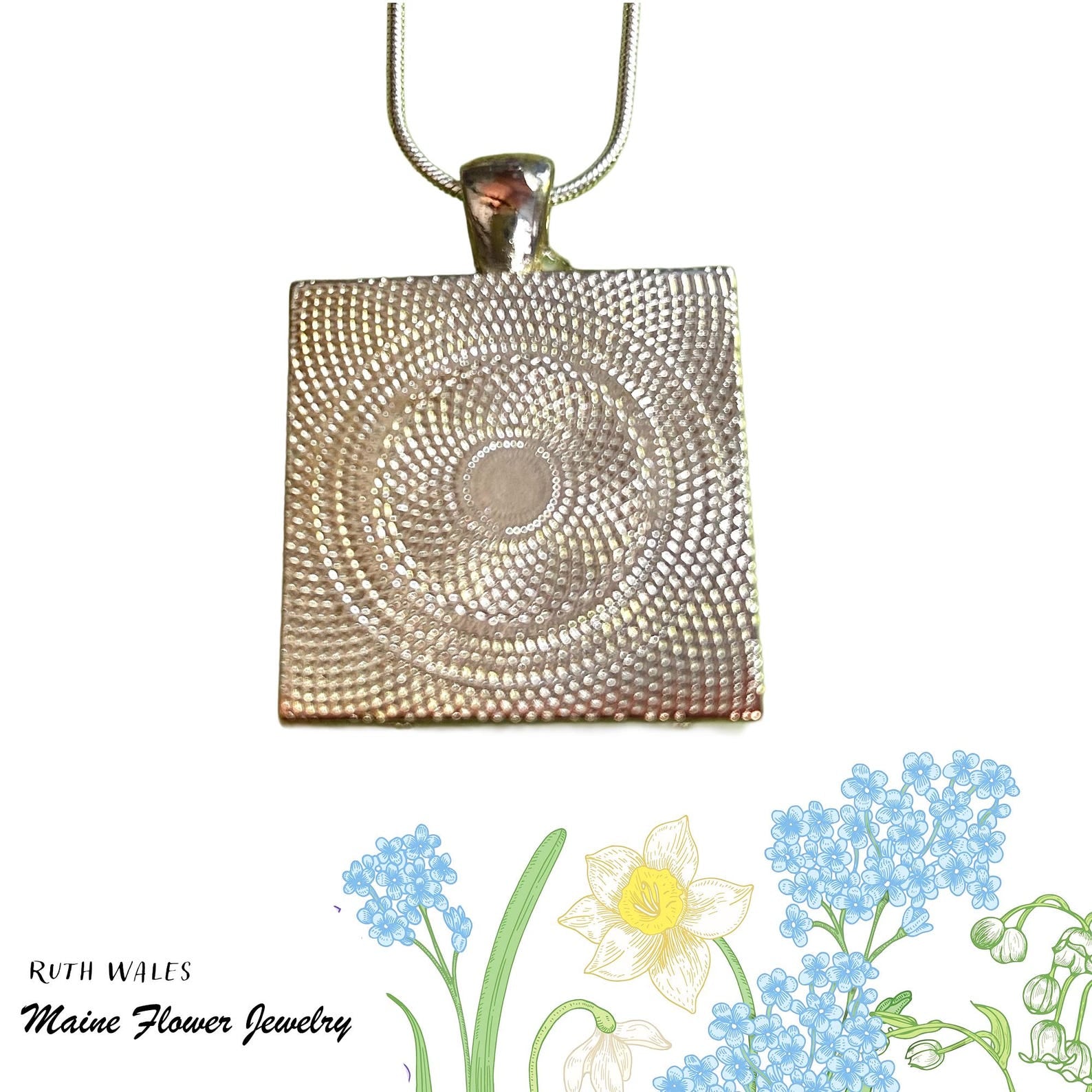 Silver textured square pendant on a white background with floral illustrations at the bottom.