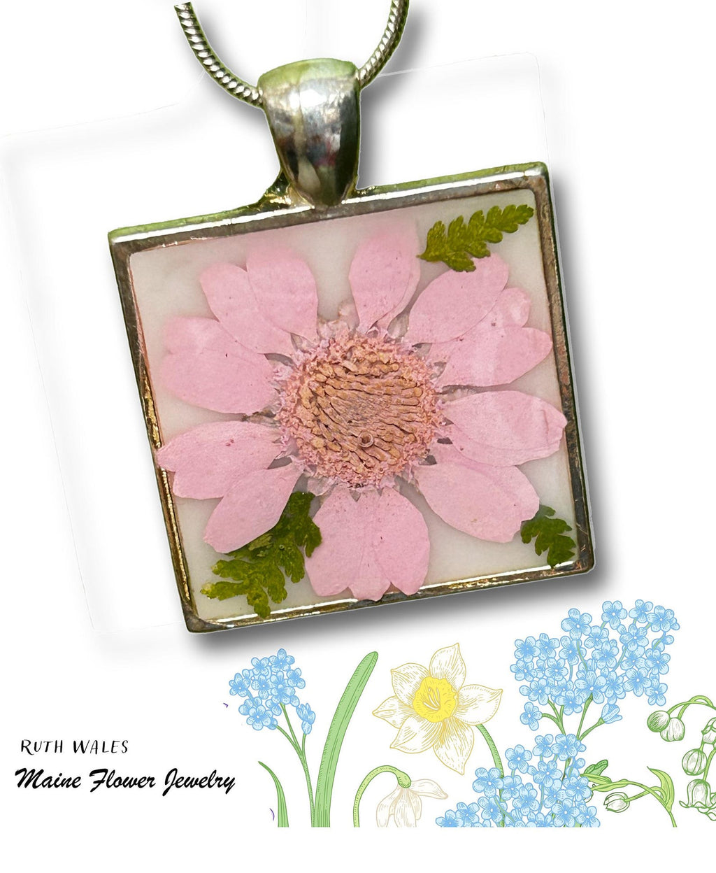Square pendant with pressed pink flower and green leaves on a white background, featuring 'Ruth Wales Maine Flower Jewelry' branding.