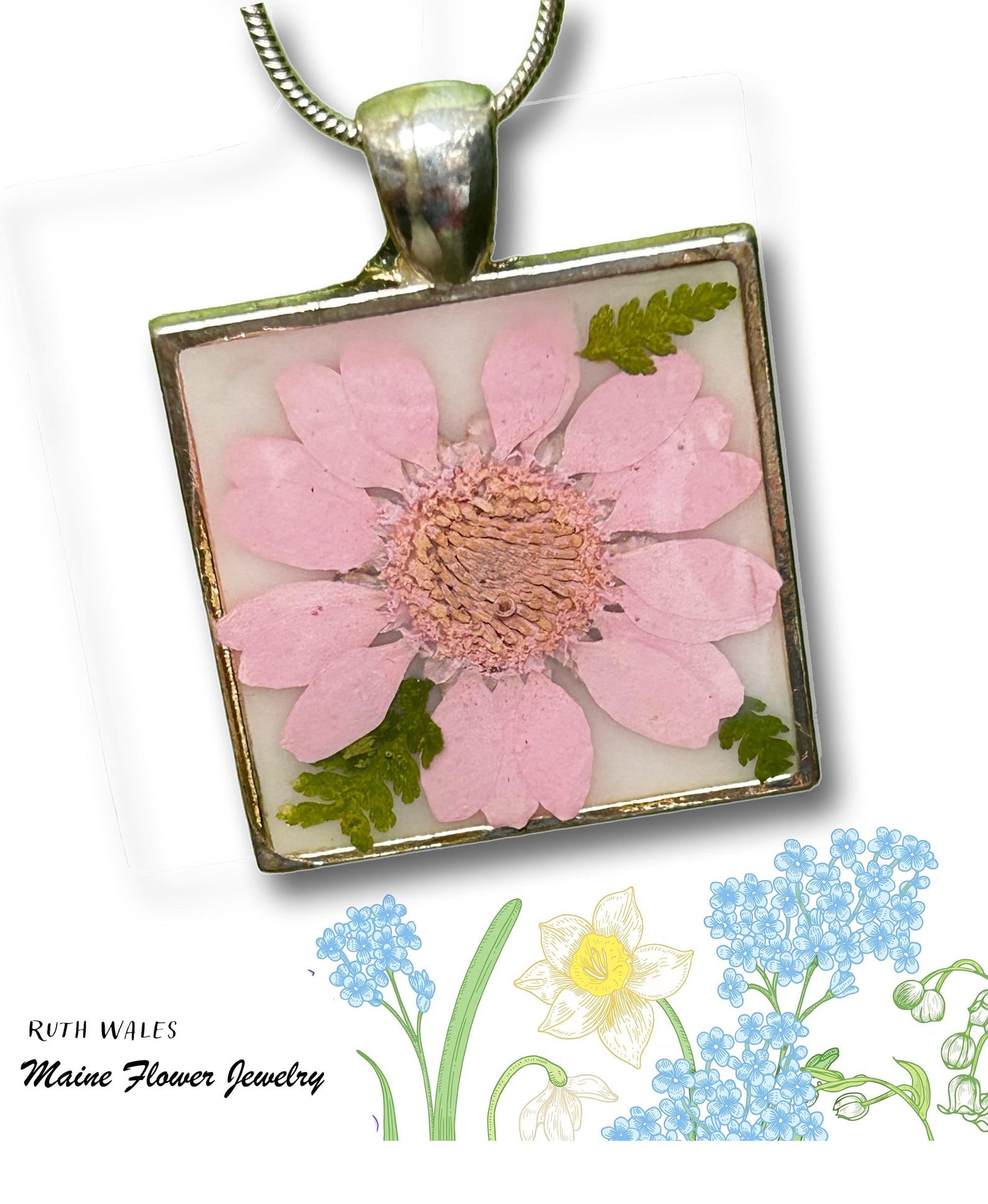 Square pendant with pressed pink flower and green leaves on a white background, featuring 'Ruth Wales Maine Flower Jewelry' branding.